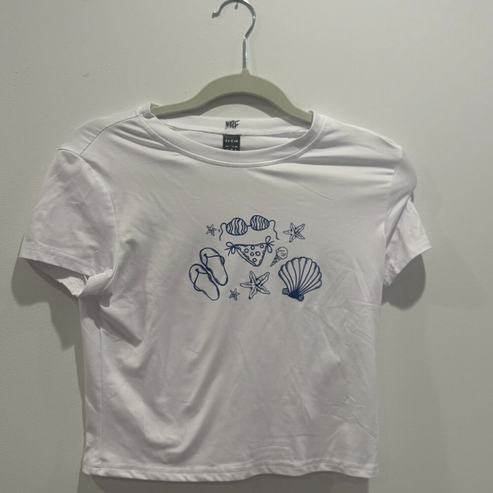 White baby tee with cute navy summer designs.